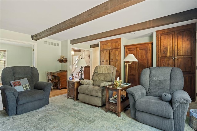 living room with visible vents and beam ceiling