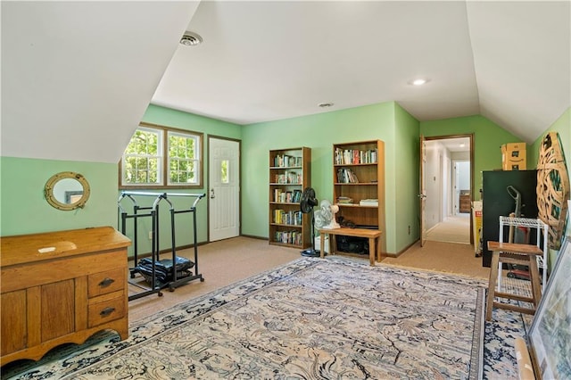 carpeted office with visible vents, baseboards, and vaulted ceiling