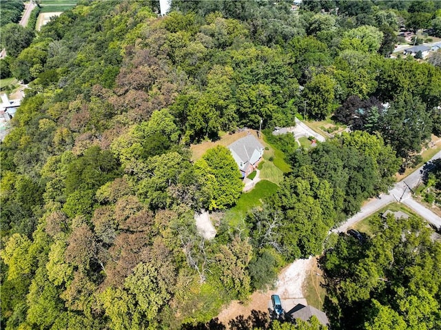 drone / aerial view with a wooded view