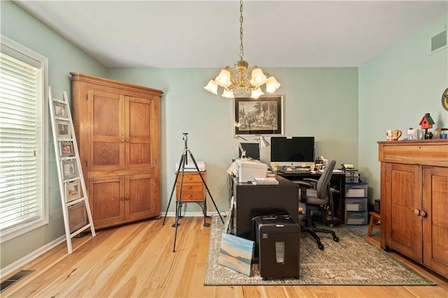 office with a chandelier, wood finished floors, visible vents, and baseboards