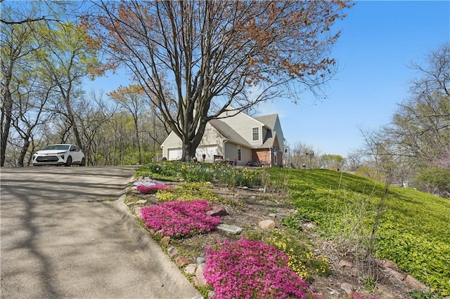view of property exterior featuring driveway and a garage