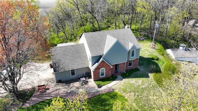 birds eye view of property with a view of trees