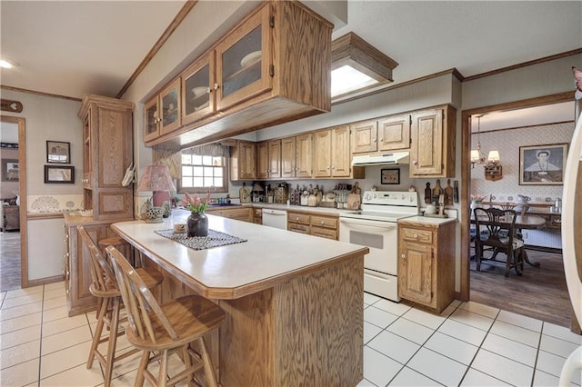 kitchen featuring ornamental molding, under cabinet range hood, wallpapered walls, white appliances, and light countertops