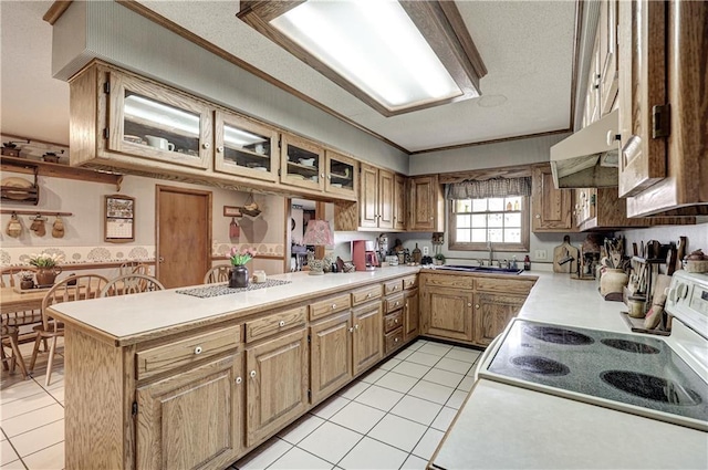 kitchen with a peninsula, light tile patterned flooring, a sink, light countertops, and electric stove