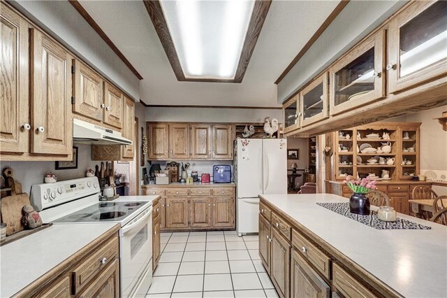 kitchen featuring ornamental molding, under cabinet range hood, white appliances, light tile patterned flooring, and light countertops