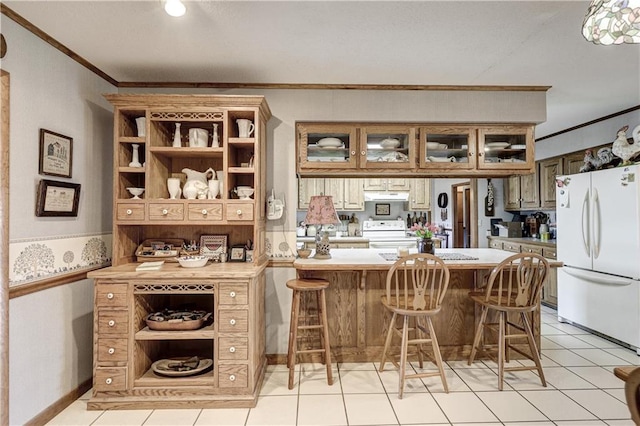 kitchen featuring crown molding, light countertops, range with electric stovetop, a peninsula, and freestanding refrigerator