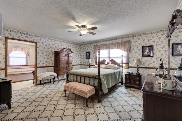 bedroom featuring wallpapered walls, multiple windows, a wainscoted wall, and a textured ceiling