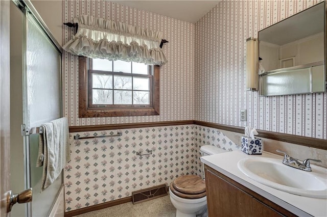 bathroom featuring visible vents, wallpapered walls, toilet, wainscoting, and vanity