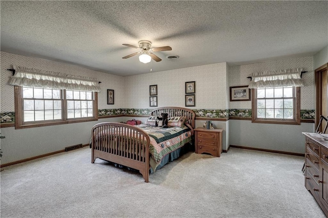 bedroom featuring multiple windows, light colored carpet, and wallpapered walls