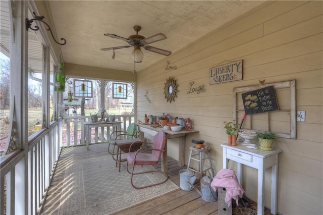 sunroom featuring a ceiling fan