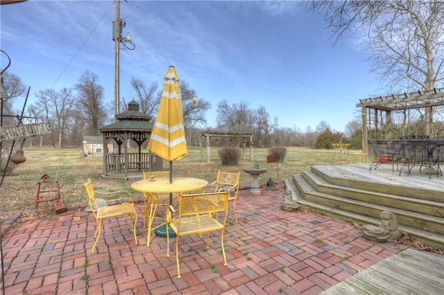 view of patio with outdoor dining area and a pergola