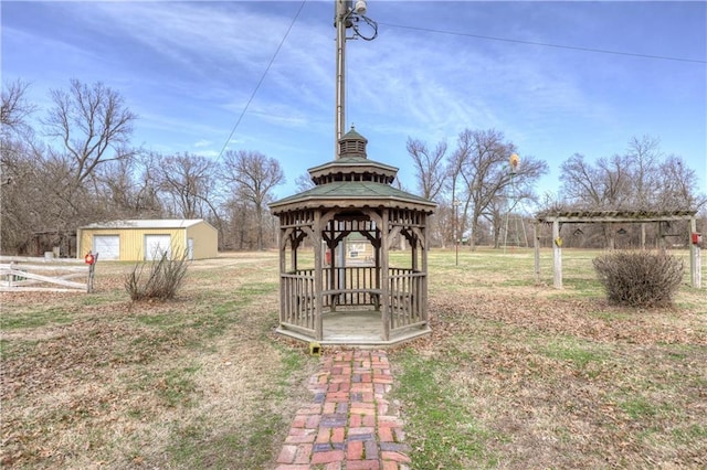 view of yard with a gazebo, a garage, and fence