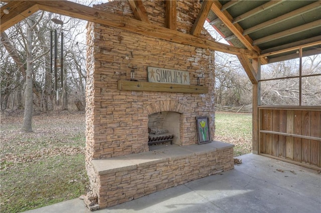 view of patio featuring an outdoor stone fireplace