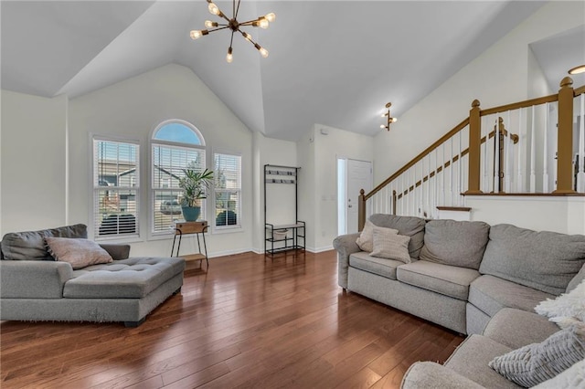 living area featuring an inviting chandelier, baseboards, wood-type flooring, and high vaulted ceiling