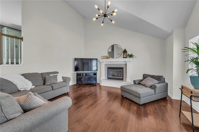 living area featuring dark wood-style floors, baseboards, high vaulted ceiling, an inviting chandelier, and a tiled fireplace