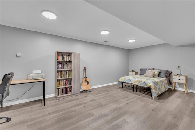 bedroom with baseboards and wood finished floors