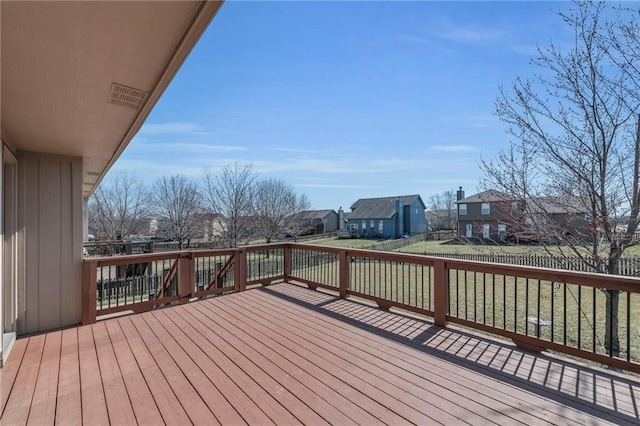 wooden terrace with a yard and a residential view