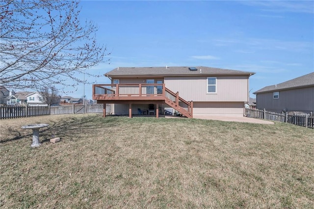 rear view of property featuring stairway, a lawn, a wooden deck, and a fenced backyard