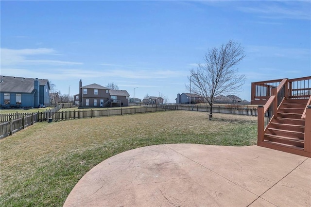 view of yard with a patio area, a residential view, stairs, and a fenced backyard