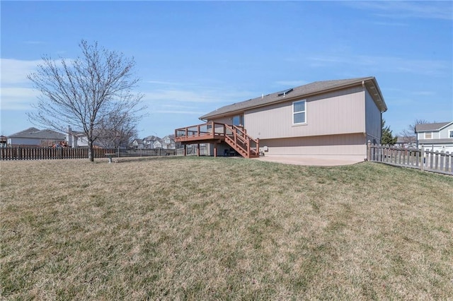 rear view of property with stairway, a lawn, and a fenced backyard