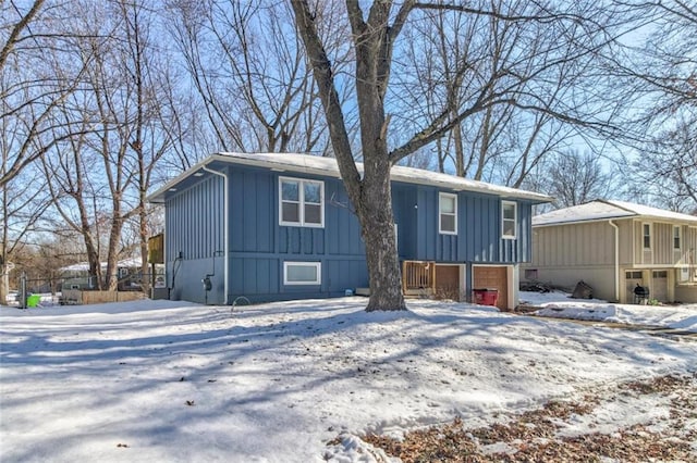 view of front facade with a garage and board and batten siding