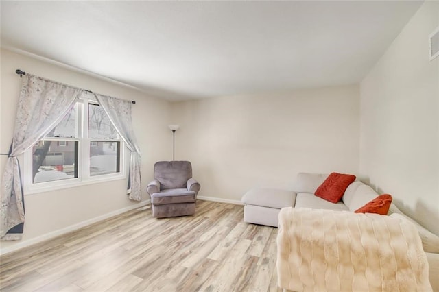 living room featuring wood finished floors and baseboards