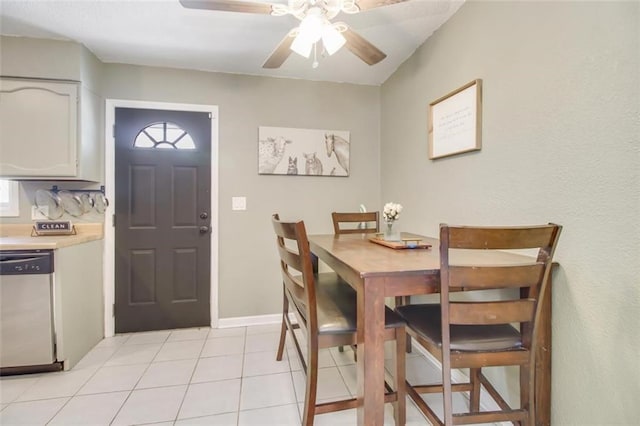 dining area with light tile patterned floors, baseboards, and a ceiling fan