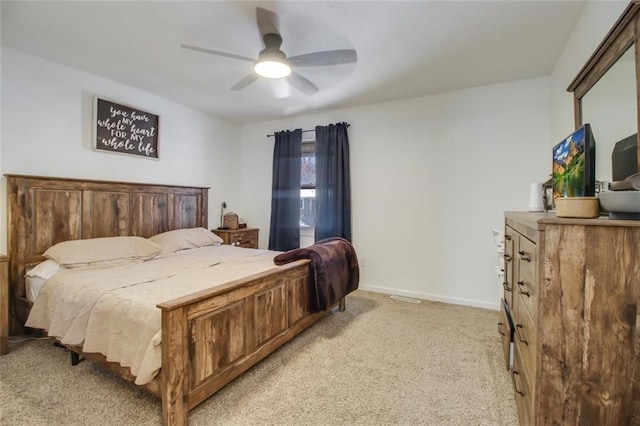 bedroom featuring ceiling fan, baseboards, and light carpet