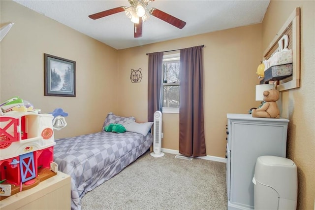 bedroom featuring a ceiling fan, carpet, and baseboards