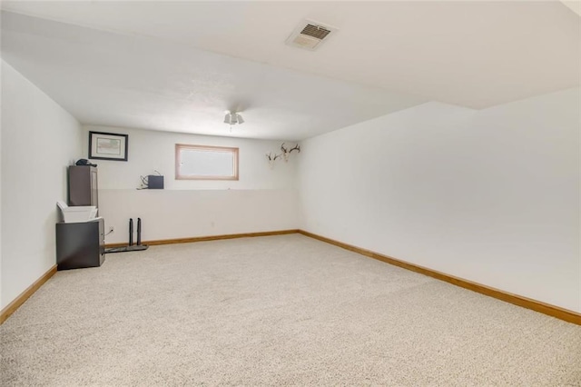 carpeted empty room with visible vents and baseboards