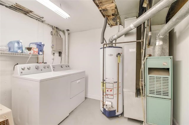 clothes washing area with baseboards, laundry area, electric panel, washer and dryer, and gas water heater