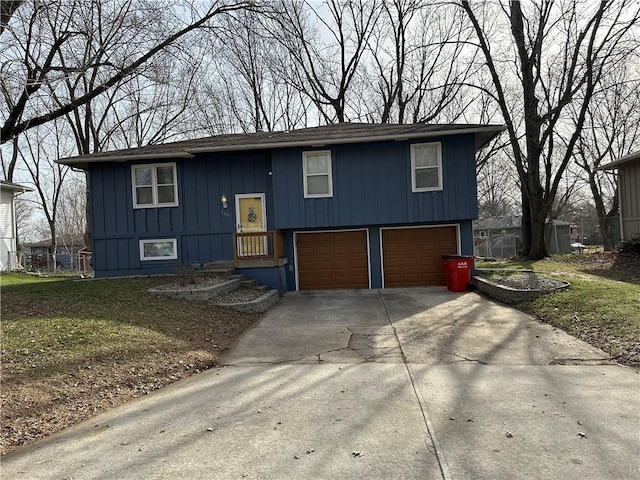 split foyer home with a garage and concrete driveway