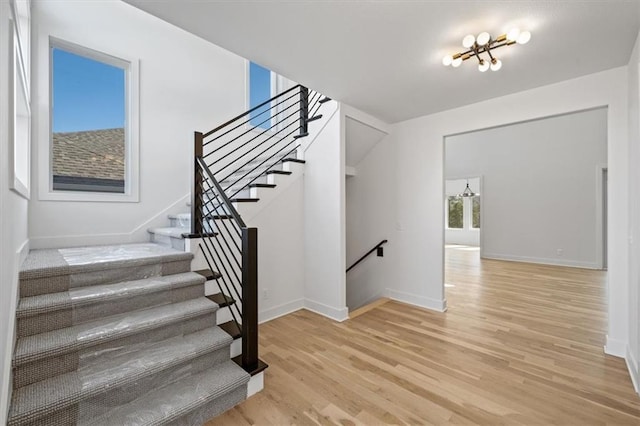 stairway with baseboards and wood finished floors