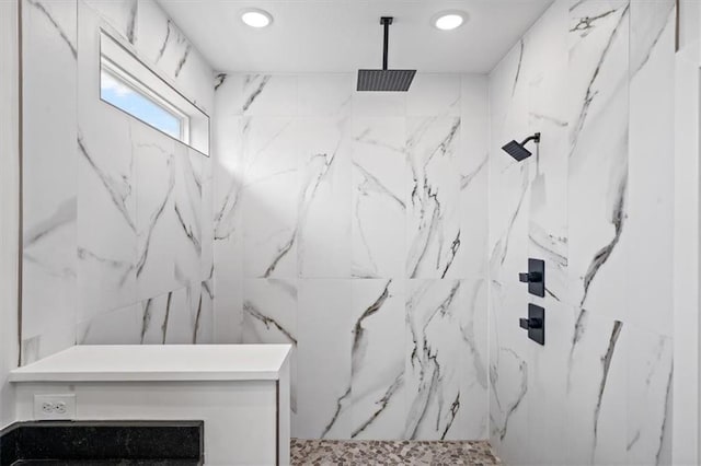 bathroom featuring a marble finish shower and recessed lighting