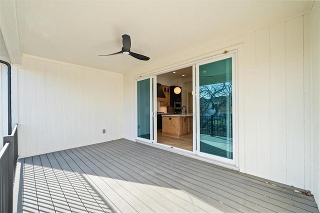 wooden terrace featuring ceiling fan