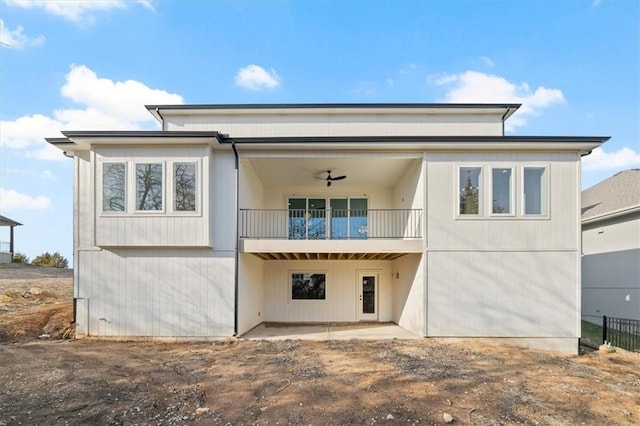 back of house featuring ceiling fan and a balcony