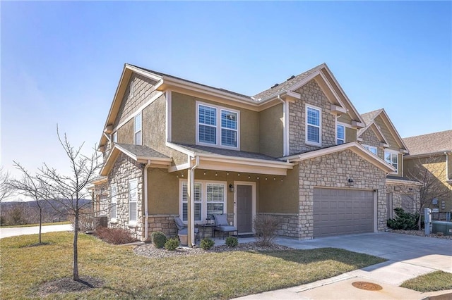 view of front of home featuring stucco siding, driveway, stone siding, a porch, and a front yard