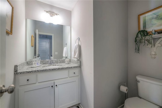 bathroom featuring toilet and vanity