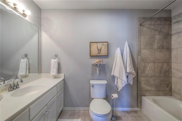 bathroom featuring tile patterned floors, baseboards, toilet, and vanity