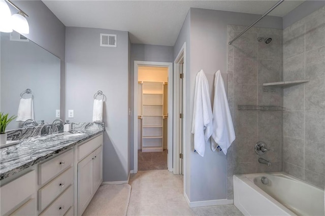 bathroom featuring visible vents, vanity, shower / bath combination, and baseboards