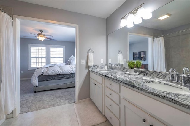 full bath featuring a sink, double vanity, a ceiling fan, and tile patterned floors