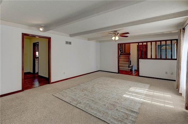 carpeted spare room featuring visible vents, beam ceiling, a ceiling fan, a textured ceiling, and stairs