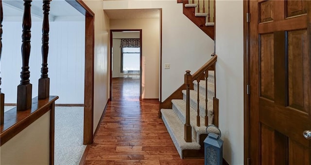 corridor with stairway and wood finished floors