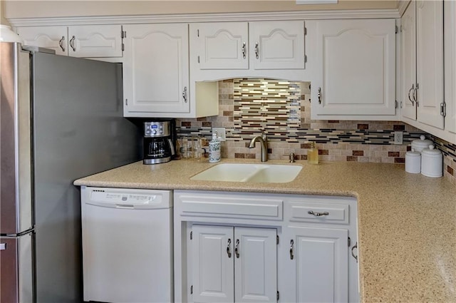 kitchen featuring dishwasher, white cabinetry, freestanding refrigerator, and a sink