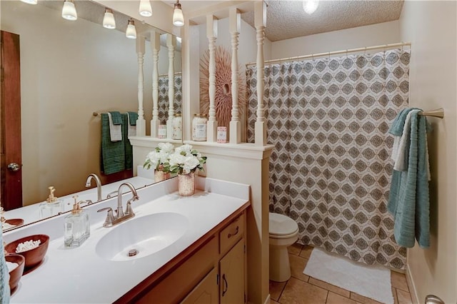 full bathroom with tile patterned floors, toilet, a textured ceiling, a shower with shower curtain, and vanity