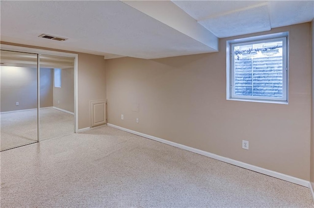 unfurnished bedroom with visible vents, a textured ceiling, a closet, carpet flooring, and baseboards