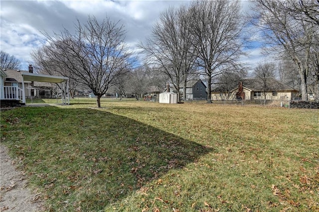 view of yard with a shed, an outdoor structure, and fence