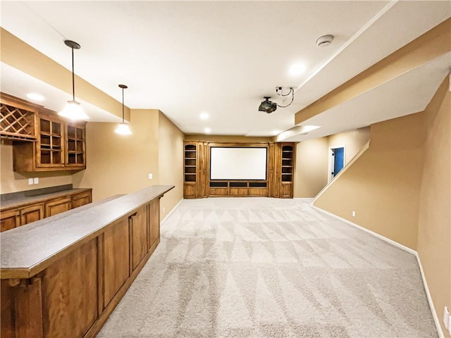 cinema featuring light carpet, built in features, bar area, and baseboards