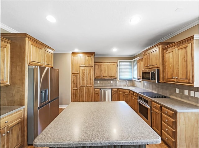 kitchen featuring a sink, crown molding, a kitchen island, and stainless steel appliances