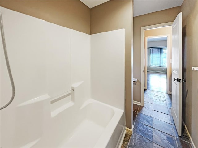 bathroom featuring baseboards and stone tile flooring